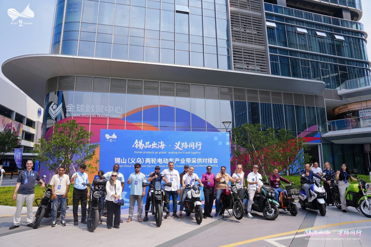 Event participants pose with electric scooters outside the Xishan-Yiwu matchmaking venue.