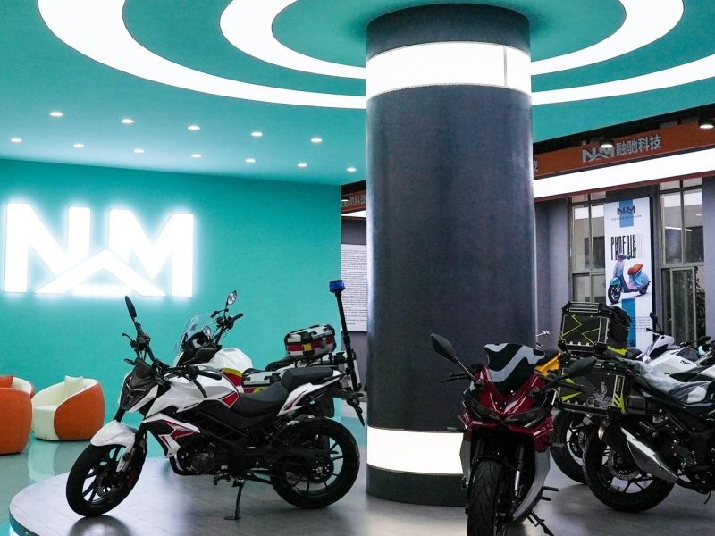 Nooma motorcycle showroom displaying various models in modern exhibition hall.